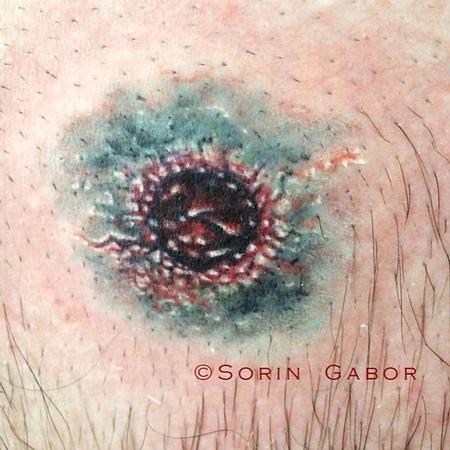 Sorin Gabor - realistic color bullet hole tattoo on chest- entry wound